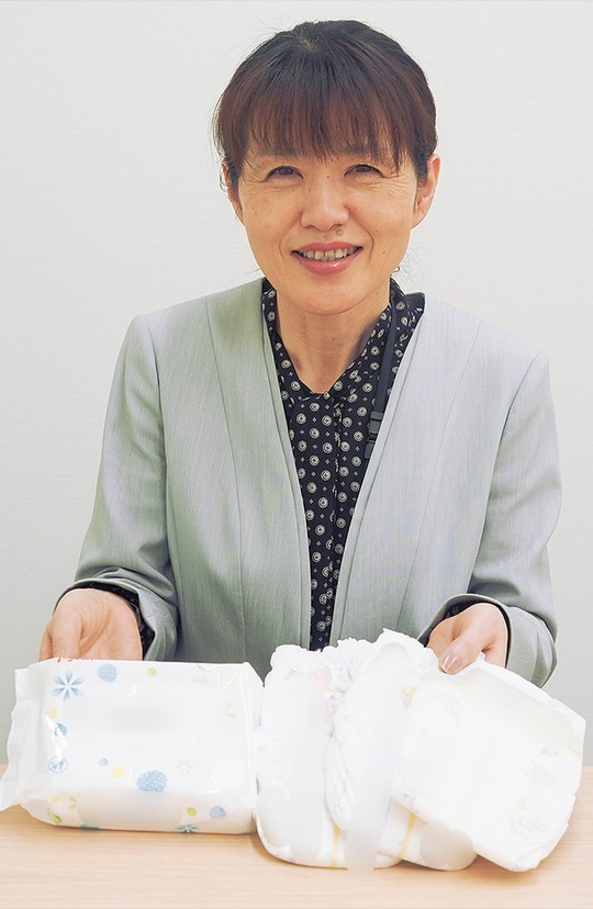 「子育ての助けになれば」と話すこどもみらい課の職員（紙おむつ等はイメージ）