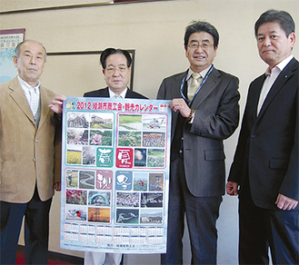 出来上がったカレンダーと作成したメンバー（写真左から大津さん、平田さん、田邉さん、栗原さん）