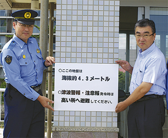 表示板を掲げる鈴木会長（右）と稲葉署長（左）