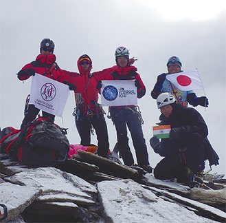 山頂に立つ５人。左から２人目が飯田さん（写真提供：飯田さん）