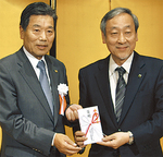 寄付金を渡す志澤会長（左）