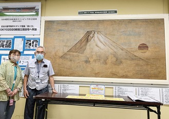 戦時中描かれたという「旭日富嶽図」を紹介する内藤さん（右）と中島さん
