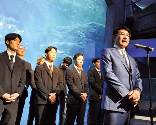 集まったスポンサーを前にあいさつする小河代表（右）ら