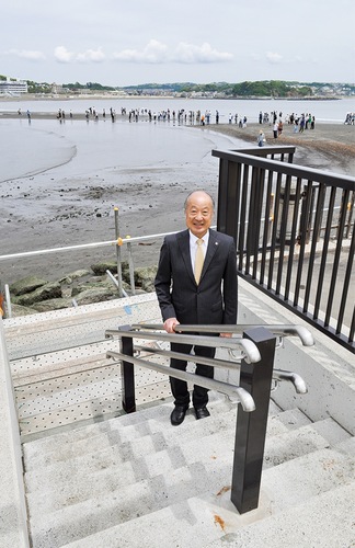 完成したばかりの管理用階段に立つ湯浅会長