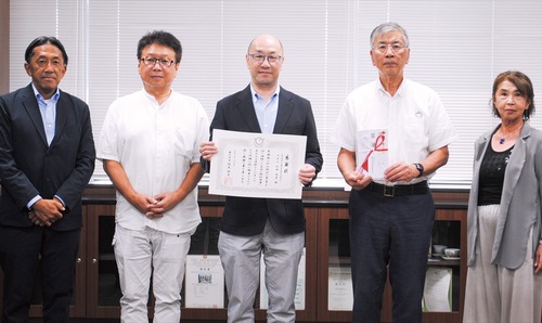 鈴木市長（中央右）と感謝状を持つ山田理事長（中央）ら