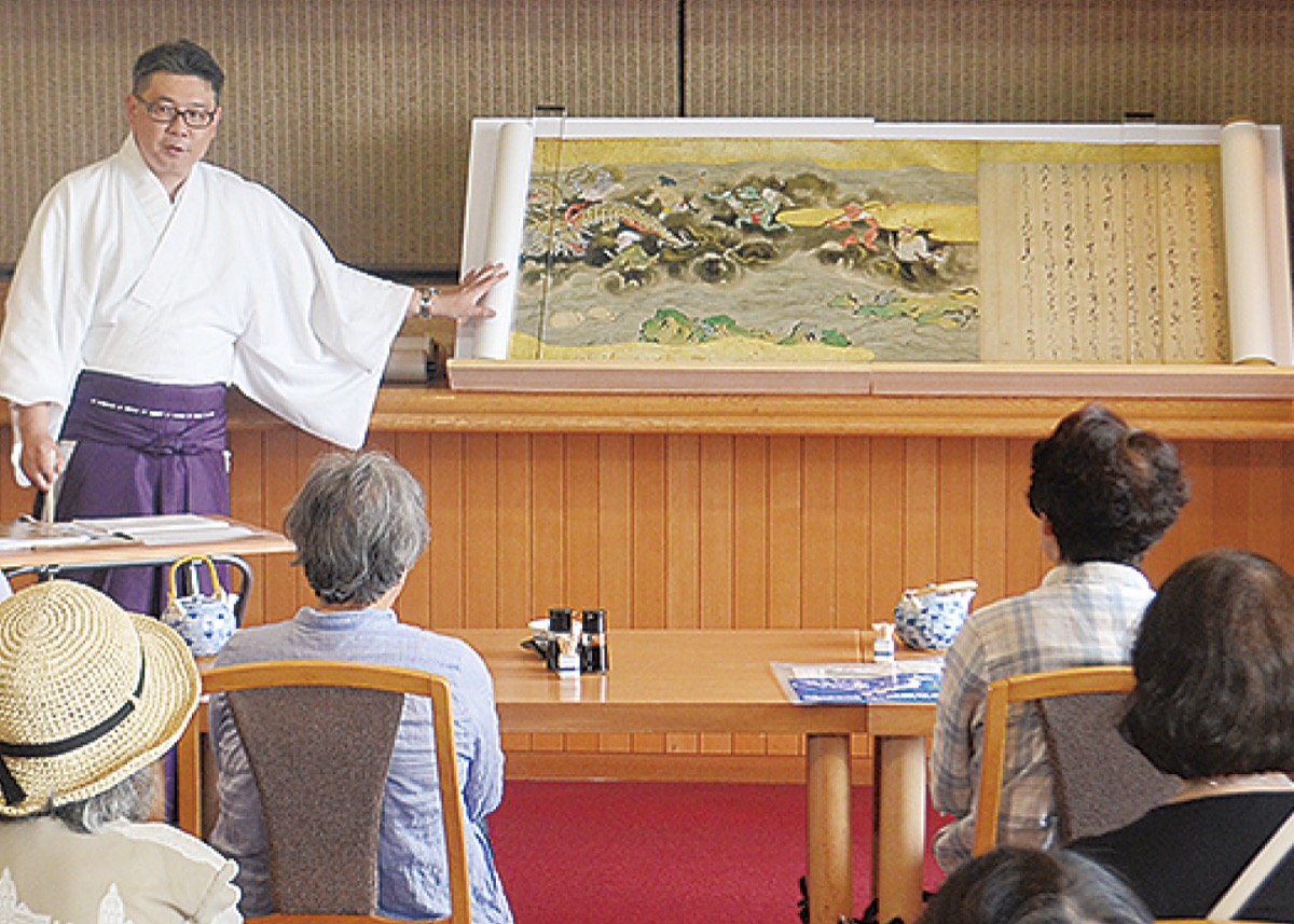 江の島の伝説を語る神職
