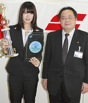 記念の盾と優勝トロフィーを手にする角田さん（左）