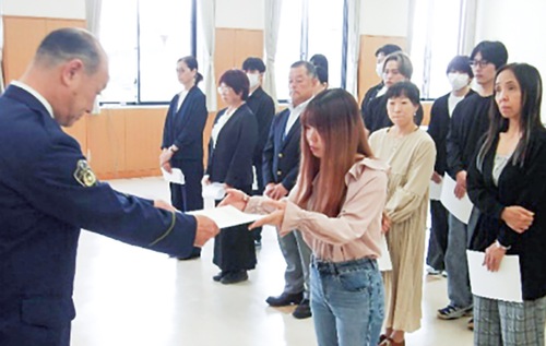 文教大生に委嘱状を手渡す鈴木署長（左）＝提供