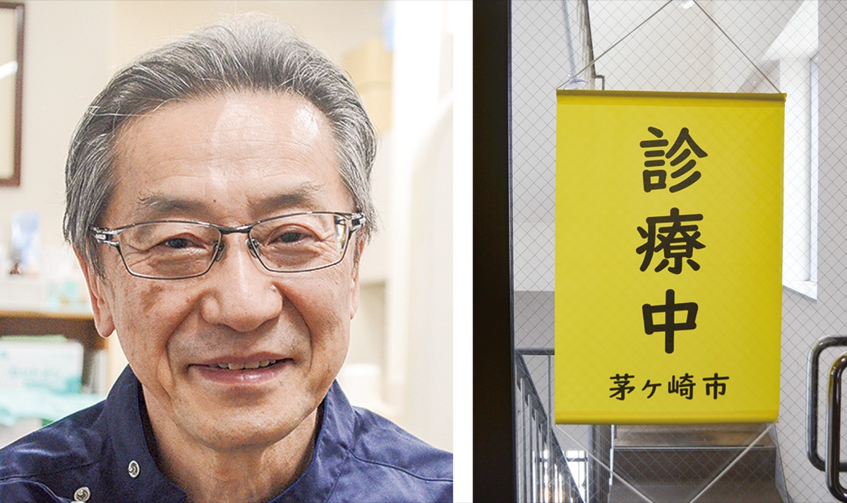 下里隆史会長（左）と、入り口や窓に吸盤で貼り付けることを想定した災害時診療対応ペナント