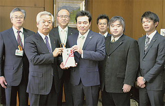 協賛金を渡す石崎理事長（左から２番目）