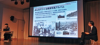 横浜市寿町の取り組みの紹介をする杉浦さん㊧と水島教授㊨