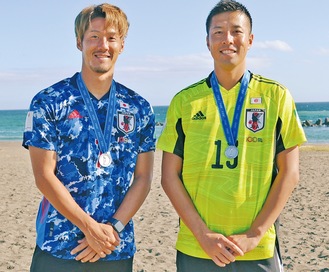平塚の海岸で取材を受ける大場選手（左）と城田選手