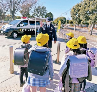 児童に声掛けする署員（須賀公園で２月25日撮影）