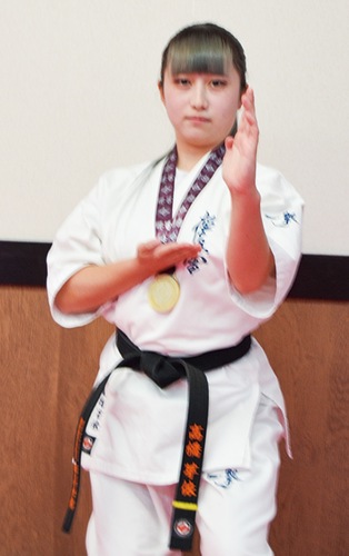 型のポーズを取る高橋さん