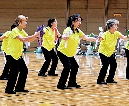 ダンベル体操を披露する参加者