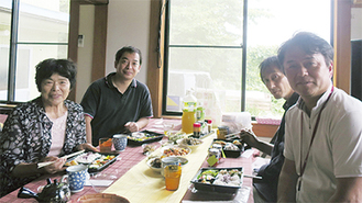 かーちゃんの手料理を囲む高橋さん(左)と川久保さん(右)