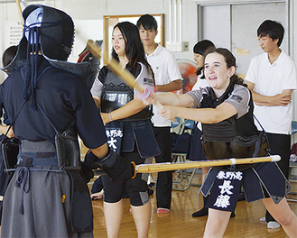 剣道部員に教わりながら、練習を体験するカジョリーナシニアカレッジの生徒たち