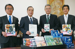 内田教育長（中央右）に図鑑を渡した三嶽会長（中央左）ら