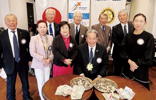 集まったコインとメンバーら